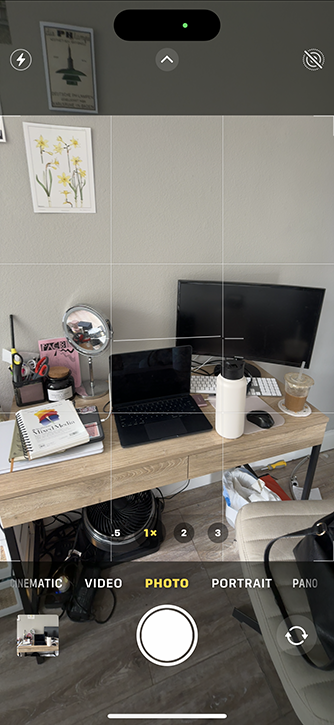 camera view of work desk with laptop and a notebook